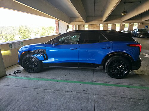 Blazer EV SS shown with its side charging port opened and in-use