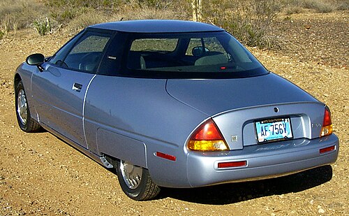 The rear three-quarters view of a car with a hidden rear wheel.