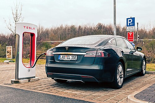 A blue Model S charging at a Supercharger