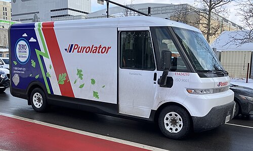 A photo of the Brightdrop Zevo 600 in Canada. You can see a red bus lane in the foreground somewhat.